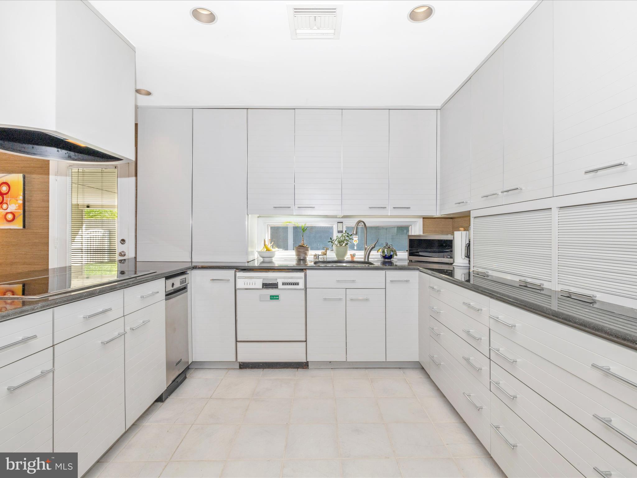 8207 Marcie Drive Baltimore, MD 21208 - Photo 23 of 67 a kitchen with cabinets appliances a sink and a window