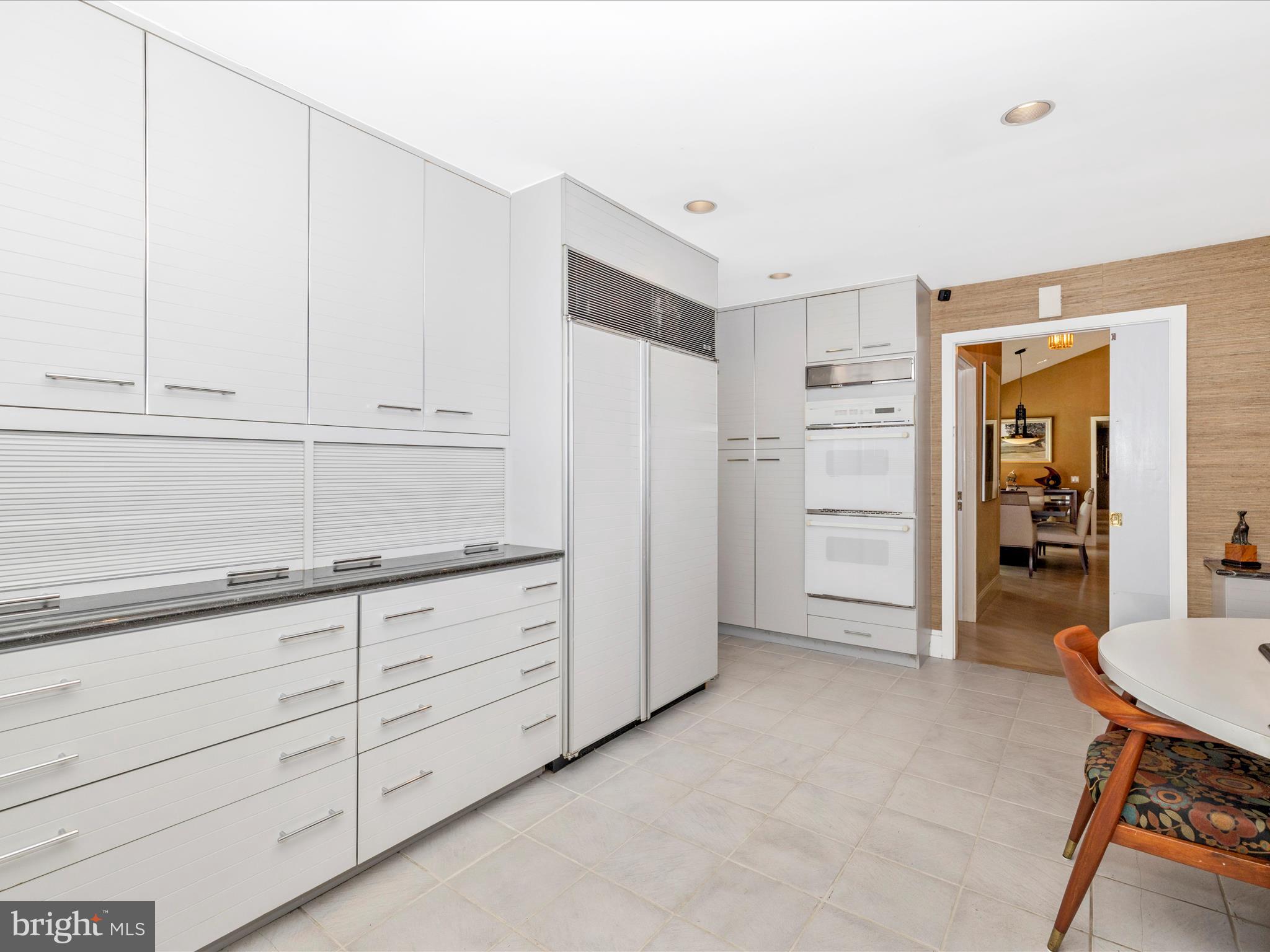 8207 Marcie Drive Baltimore, MD 21208 - Photo 24 of 67 a kitchen with granite countertop cabinets and refrigerator