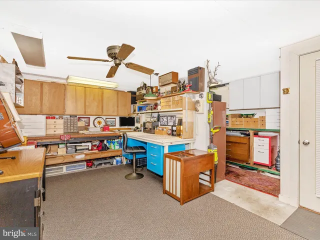 a spacious bedroom with a bed and a chandelier