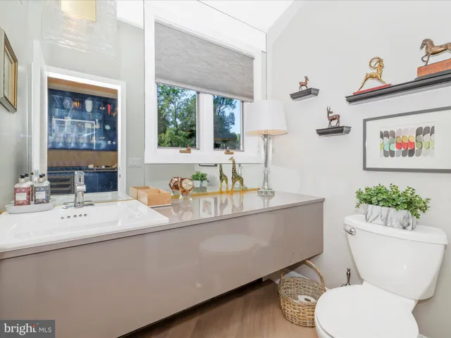 a spacious bathroom with a granite countertop sink and a large mirror