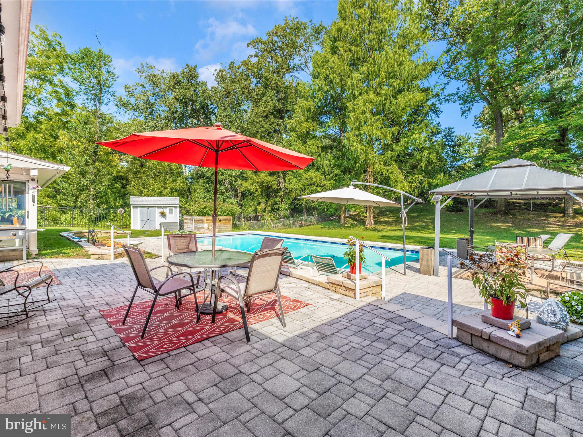 8207 Marcie Drive Baltimore, MD 21208 - Photo 51 of 67 a view of a patio with a table and chairs under an umbrella