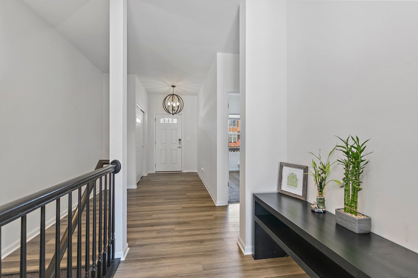 335 Snowdrop Lane Elgin, IL 60124 - Photo 2 of 25 a view of a hallway with potted plants