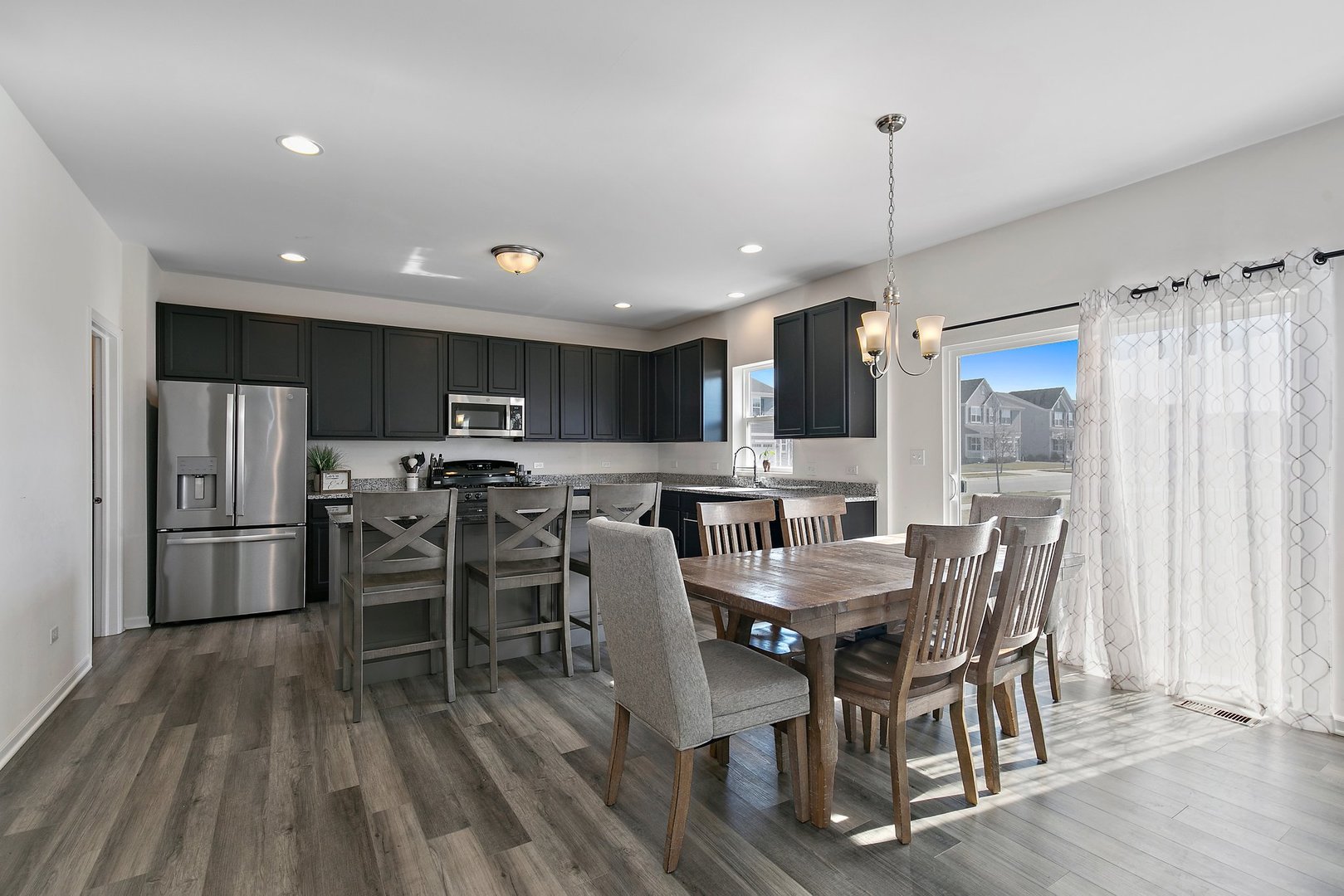 335 Snowdrop Lane Elgin, IL 60124 - Photo 5 of 25 a view of a dining room with furniture window and wooden floor