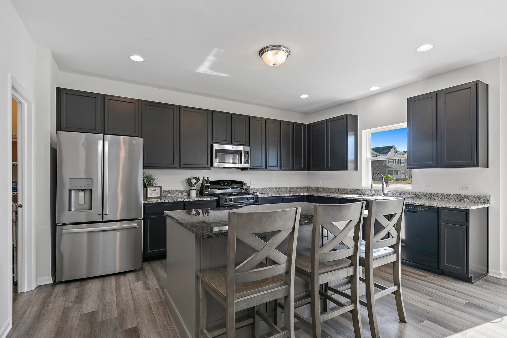 335 Snowdrop Lane Elgin, IL 60124 - Photo 6 of 25 a kitchen with stainless steel appliances a refrigerator a stove a sink and a center island