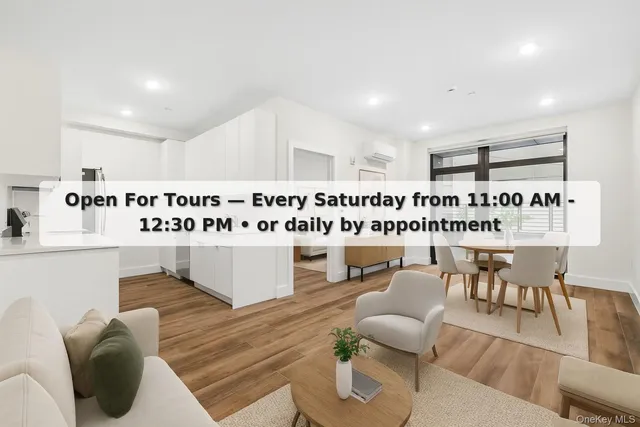 a living room with furniture a rug and white walls