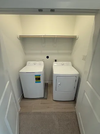 a living room with furniture a large window and a table