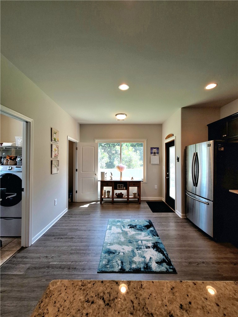 3 Cringle Lane Anderson, SC 29625 - Photo 4 of 26 A streamlined kitchen entry flows into a functional laundry area, showcasing modern finishes.
