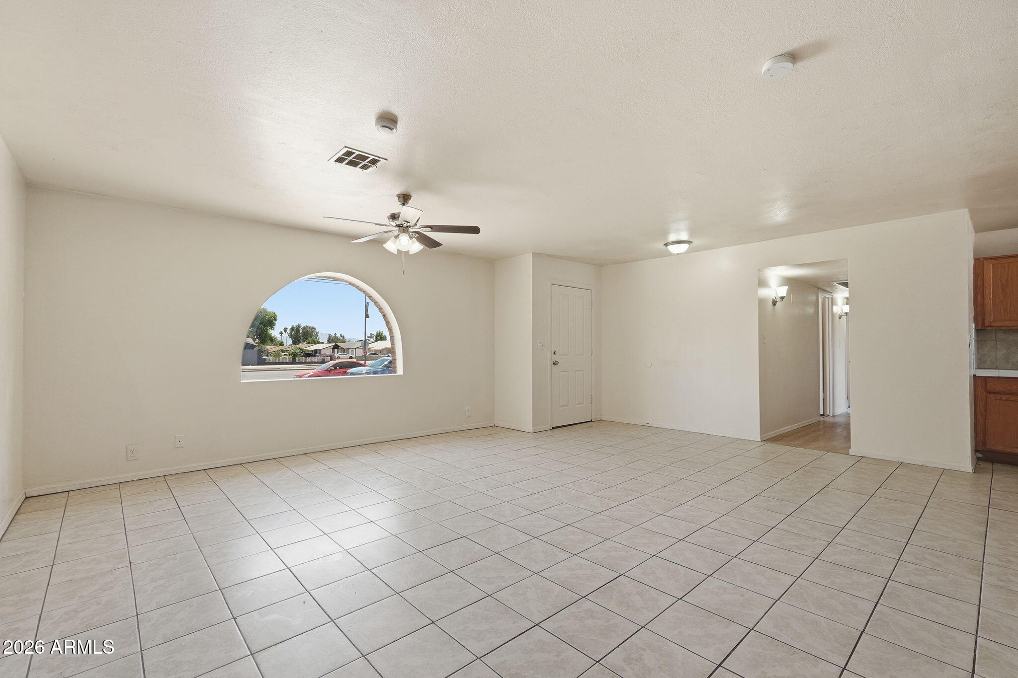 6452 West Thomas Road Phoenix, AZ 85033 - Photo 4 of 30 an empty room & a ceiling fan window