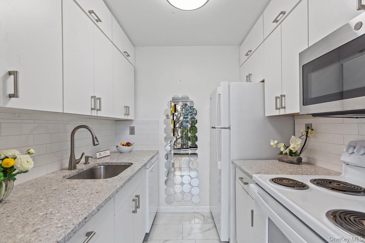 150 Overlook Avenue, Unit 3K Peekskill, NY 10566 - Photo 1 of 1 a kitchen with stainless steel appliances granite countertop a sink stove and refrigerator