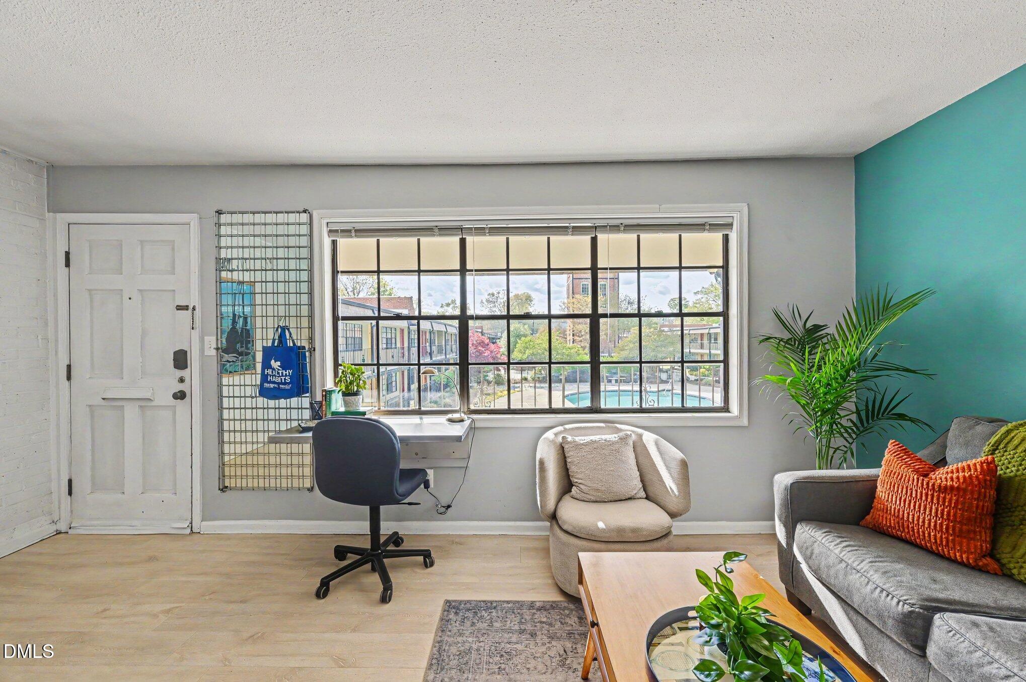 807 West Trinity Avenue, Unit 252 Durham, NC 27701 - Photo 3 of 23 a living room with furniture and a large window
