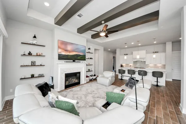 a living room with furniture fireplace and flat screen tv