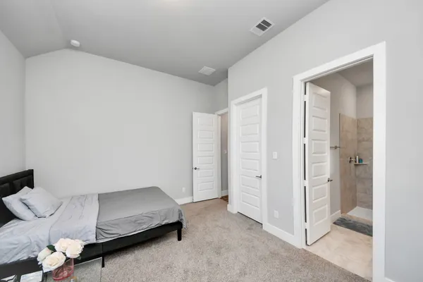 a living room with furniture and a walk in closet
