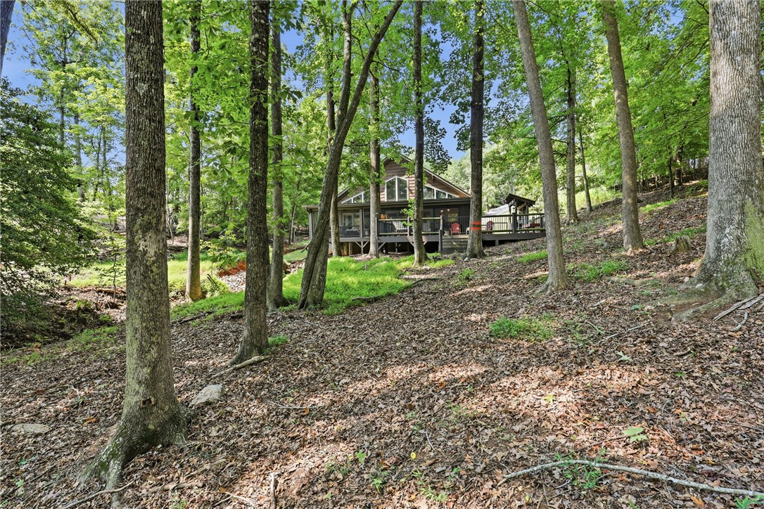 1110 Sunset Lane Anderson, SC 29626 - Photo 27 of 38 Nestled in a verdant hillside, this tranquil retreat features an expansive deck for outdoor enjoyment.