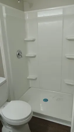 a bathroom with a toilet and a shower
