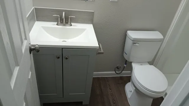 a white toilet sitting next to a bathroom sink