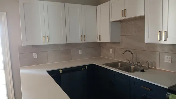 a kitchen with a sink and cabinets