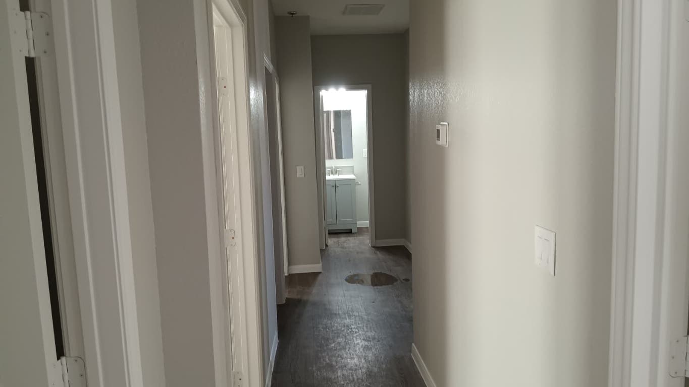 611 Carpenter Avenue, Unit 201 Austin, TX 78753 - Photo 6 of 17 a view of a hallway with wooden floor