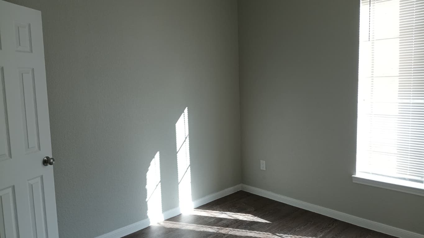 611 Carpenter Avenue, Unit 201 Austin, TX 78753 - Photo 7 of 17 a view of a small space with wooden floor and a window