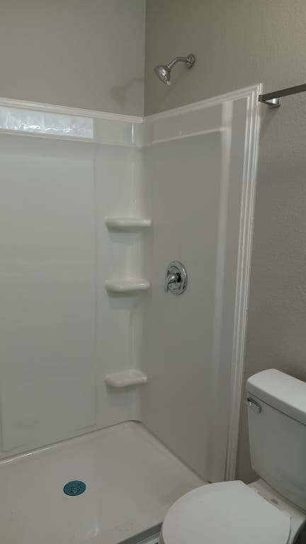 611 Carpenter Avenue, Unit 201 Austin, TX 78753 - Photo 8 of 17 a bathroom with a toilet and a shower
