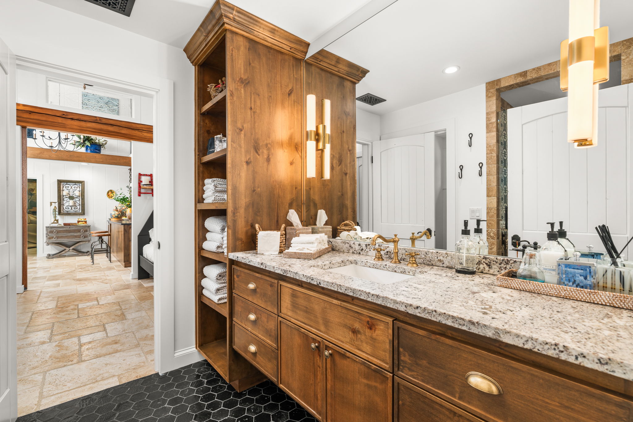 11941 Overlook Pass Austin, TX 78738 - Photo 24 of 40 Bathroom for the flex room, featuring a wood vanity with integrated shelving, granite countertop, dual wall sconces, and hexagon tile flooring