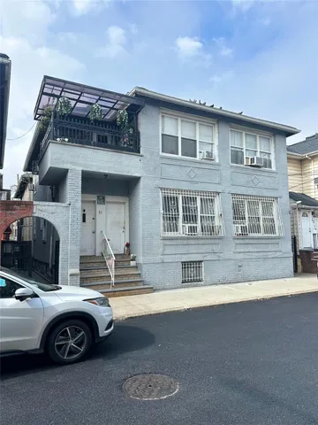 a front view of a house with parking space