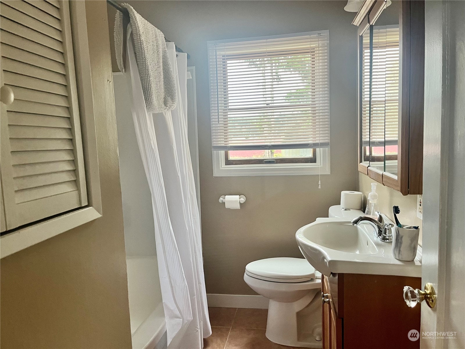 2998 Alexson Road Grayland, WA 98547 - Photo 16 of 27 a bathroom with a sink a toilet and a window