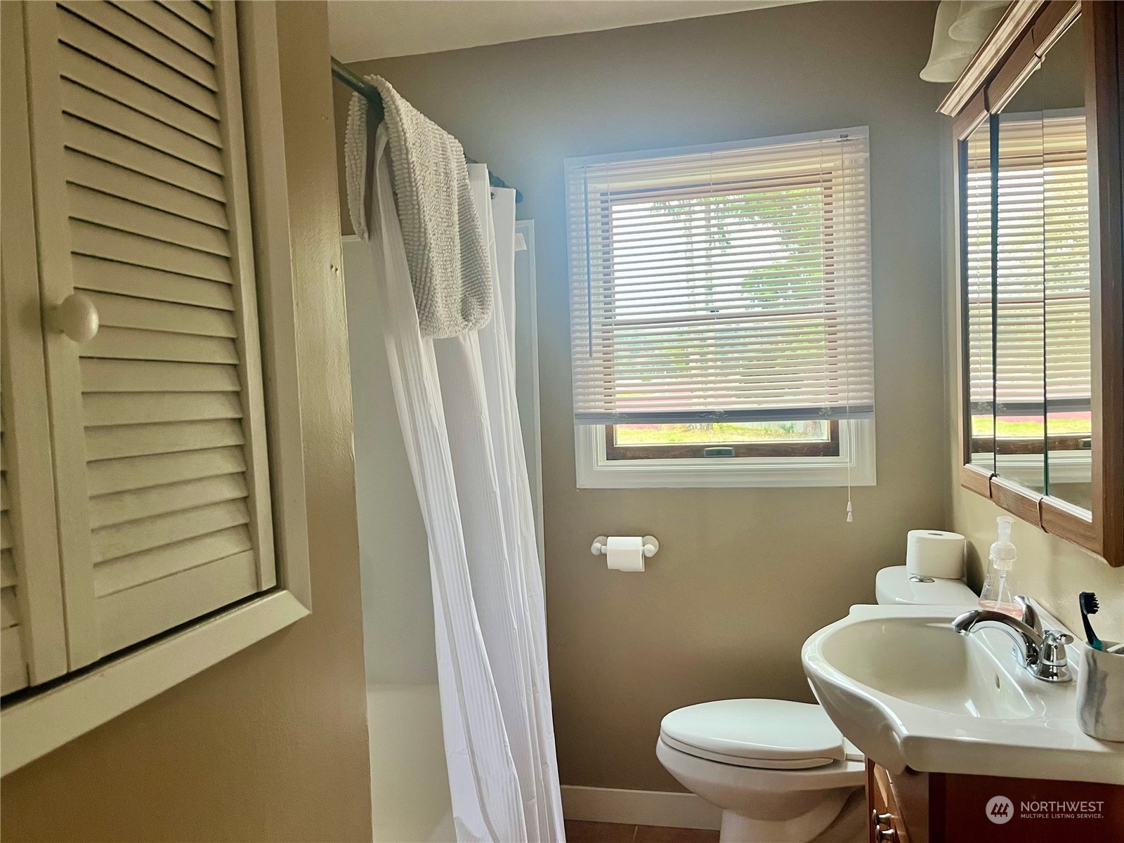 2998 Alexson Road Grayland, WA 98547 - Photo 17 of 27 a bathroom with a sink a toilet and tub
