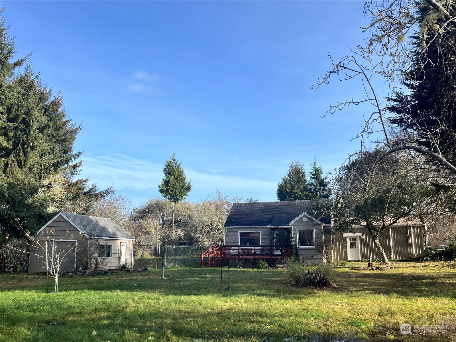 2998 Alexson Road Grayland, WA 98547 - Photo 3 of 27 a front view of a house with a garden and trees