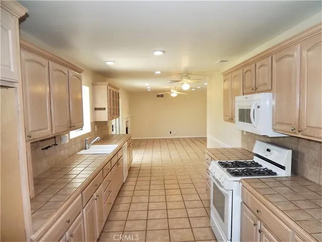 a view of a kitchen with a stove and a refrigerator