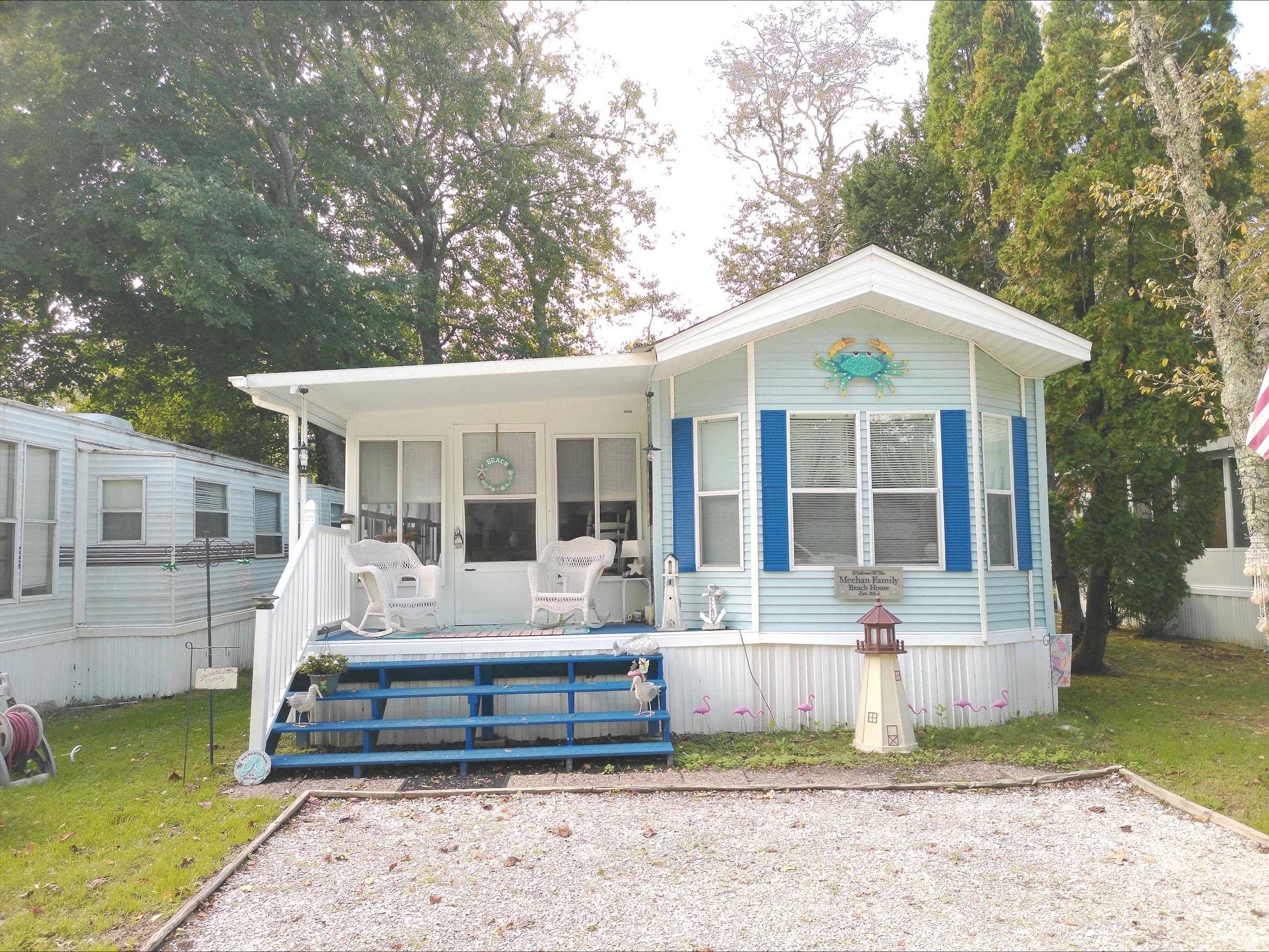 a front view of a house with a garden and yard