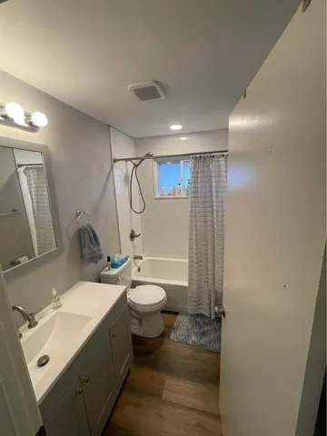 a bathroom with a double vanity sink toilet and shower