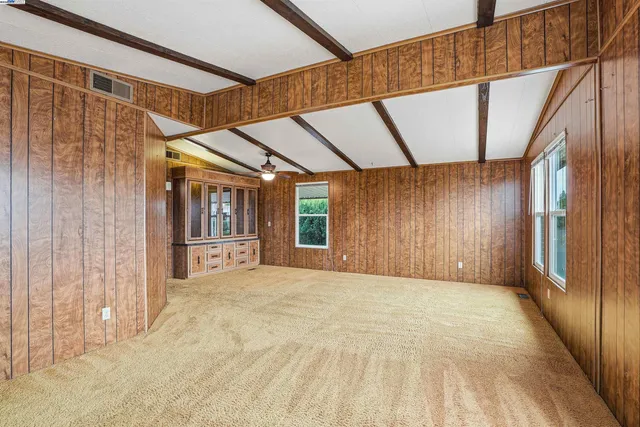 a view of a porch with wooden floor and door