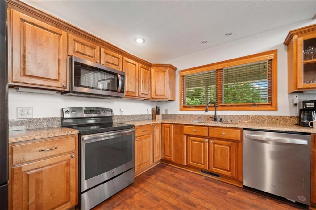 82 Emelia Road Morganton, GA 30560 - Photo 11 of 45 a kitchen with stainless steel appliances granite countertop wooden cabinets stove top oven and sink