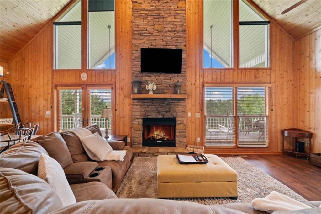 82 Emelia Road Morganton, GA 30560 - Photo 17 of 45 a living room with furniture a fireplace and a floor to ceiling window