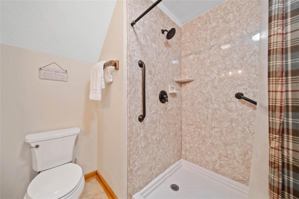 82 Emelia Road Morganton, GA 30560 - Photo 28 of 45 a white toilet sitting next to a bath tub shower