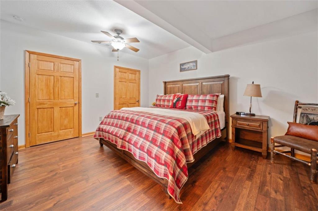 82 Emelia Road Morganton, GA 30560 - Photo 37 of 45 a bedroom with a bed and dresser with wooden floor