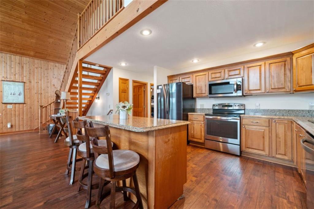 82 Emelia Road Morganton, GA 30560 - Photo 10 of 45 a kitchen with stainless steel appliances granite countertop a stove top oven a sink a dining table and chairs with wooden floor