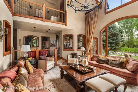 a living room with furniture and a floor to ceiling window