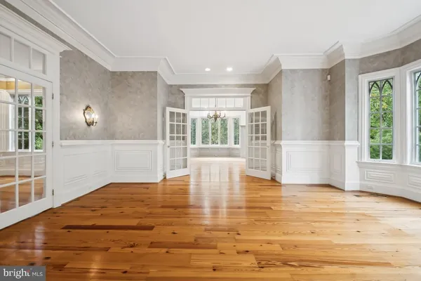 a view of a room with wooden floor and bedroom