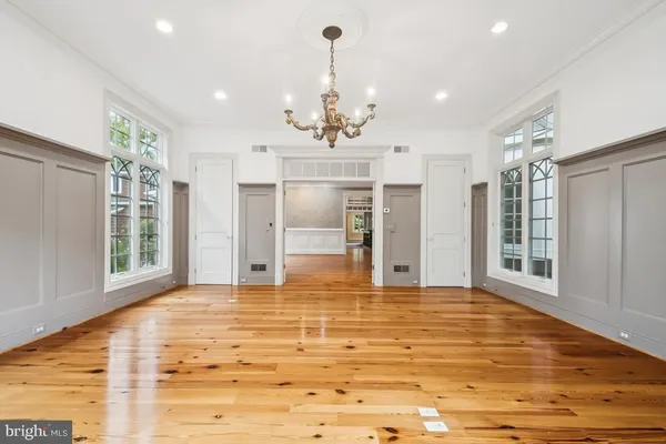 a view of staircase with lots of frames on wall and windows