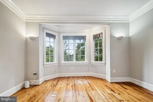 a view of a livingroom with a ceiling fan and window in a room
