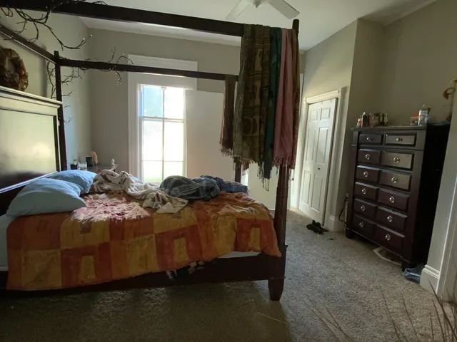 a bedroom with a bed and a television