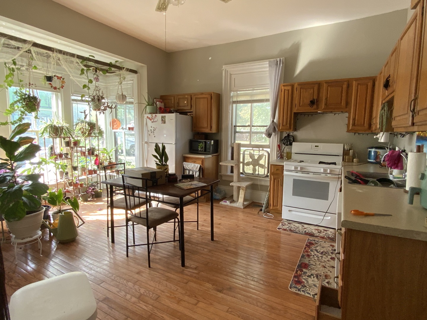 404 South Batavia Avenue Batavia, IL 60510 - Photo 15 of 37 a kitchen with stainless steel appliances a stove a refrigerator a dining table and chairs with wooden floor
