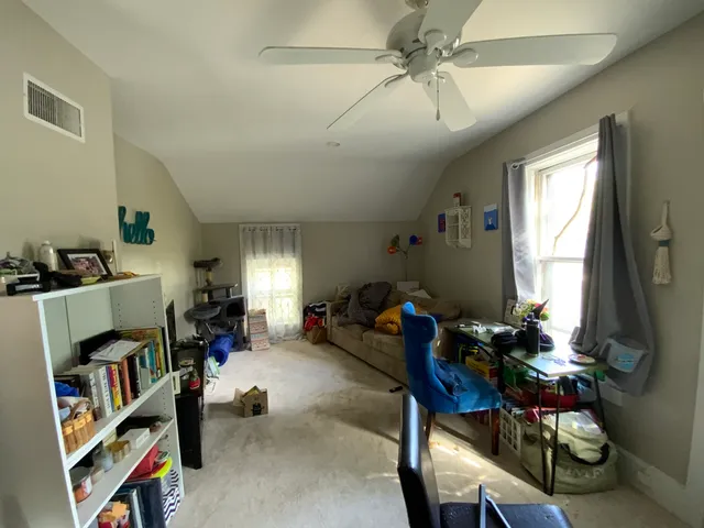 a living room with furniture and a book shelf