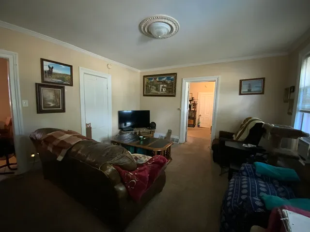 a bedroom with furniture and a flat screen tv