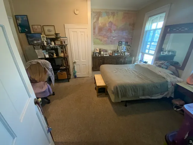 a bed sitting in a room next to a window