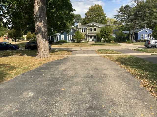 a front view of a building with trees