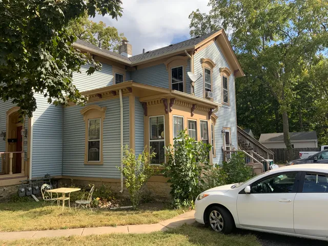 a view of a car parked front of a house
