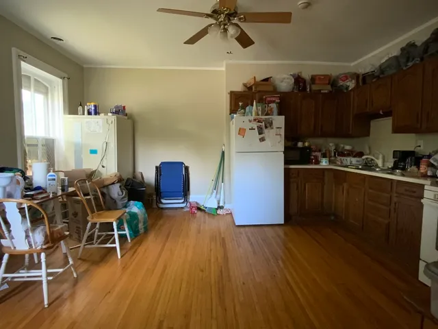 a kitchen with stainless steel appliances wooden floors stove top oven and cabinets
