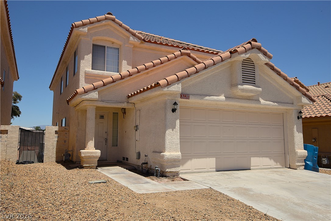 8220 Maplestar Road Las Vegas, NV 89128 - Photo 2 of 29 A desert oasis, this two-story stucco home features a two-car garage and terracotta roof tiles.